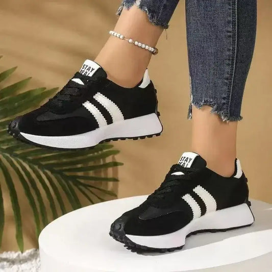 Retro Sneakers Casual Running Shoes in black with white sole, worn outdoors